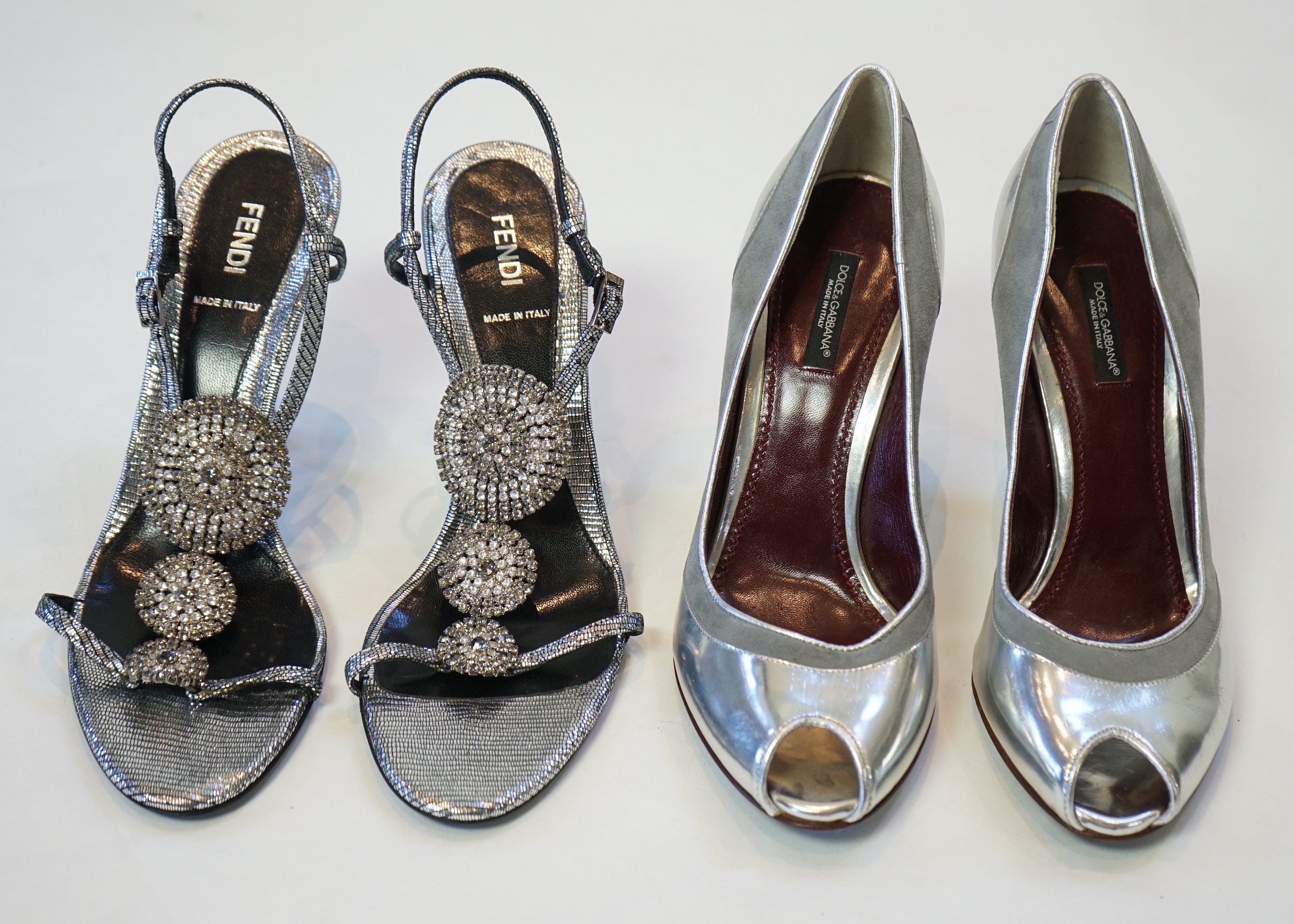 A pair of Fendi lady's metallic silver sandals with three diamante circle detail and a pair of Dolce and Gabbana silver patent leather and suede peep toe heels, size EU 39/40